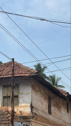 an old run down building with power lines above it