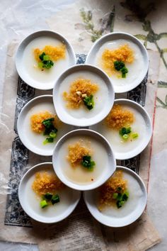 several plates with food on them are arranged in a pattern, including broccoli florets and crumbs