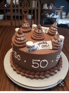 a birthday cake with chocolate frosting and googly eyes for someone's 50th