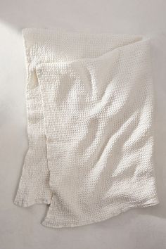 two pieces of white cloth folded on top of each other