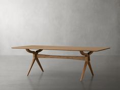 a wooden table sitting on top of a cement floor