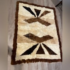 a brown and white area rug on the floor