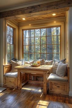 a wooden table sitting next to a window in a living room