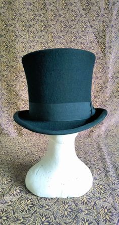 "Victorian style top hat in merinos wool, dome h 15 cm, brim 5 cm, outer band in black cotton h 4 cm, interior lined in white satin, internal sweatband in soft black leather. Entirely hand-made and sewn, the wing has the typical \"curl\" with the grosgrain finish sewn and turned used for the top hats and bowler hats of the 19th century." Winter Formal Black Costume Hats And Headpieces, Formal Black Costume Hats For Winter, Black Formal Winter Costume Hat, Formal Black Winter Costume Hat, White Top Hat, Classic Short Brim Costume Hat For Winter, Classic Short Brim Winter Costume Hat, Classic Black Brimmed Boater Hat, Black Fitted Top Hat For Formal Occasions