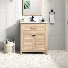 a bathroom with a sink, mirror and towel rack on the wall next to it