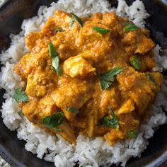 a bowl filled with rice and chicken curry