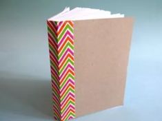 an open book with multicolored chevron paper on the front and back cover