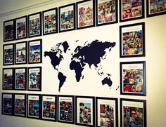 a world map is on the wall with many pictures around it