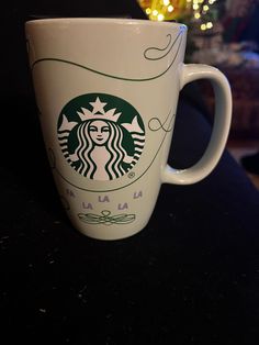 a starbucks coffee cup sitting on top of a table