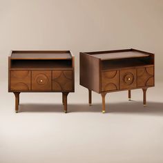 two wooden drawers with gold handles on each side and an open drawer in the middle