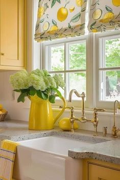 a yellow pitcher with flowers in it sitting on a kitchen counter next to a sink