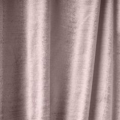 a close up view of a pink curtain