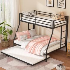 a black metal bunk bed sitting on top of a wooden floor next to a window