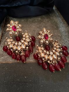 These antique Red Kundan earrings with red droplets will add the perfect charm to your festive wear. Length 8 cms Width 5.7 cms Weight 68 grams a pair Red Earrings Indian, Red Ruby Drop Earrings, Traditional Red Pearl Earrings For Party, Red Pearl Drop Earrings For Festive Occasions, Red Pearl Drop Earrings For Wedding, Festive Red Pearl Drop Earrings, Red Ruby Dangle Earrings, Red Pearl Drop Jewelry For Festive Occasions, Red Pearl Earrings For Celebration