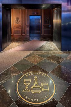 The modern moody entrance to the Baccarat Hotel in NYC with the golden emblem in the marble floors reflects the modern luxury interior design trend. Nyc Shops, Baccarat Hotel, New York City Itinerary, New York City Bars, City Interior Design, Places In New York City, Interior Design New York, Paint Color Guide, Nyc Hotel