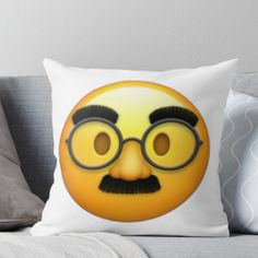 a yellow emoticure with glasses and mustache on it's face throw pillow