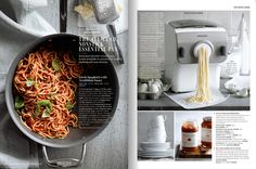 an open magazine with spaghetti and sauces in the bowl next to a blender