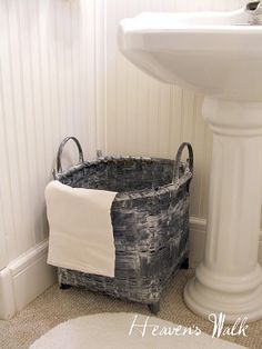 a white sink sitting next to a bath tub in a bathroom under a faucet