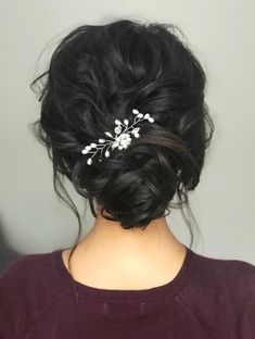 a woman wearing a hair comb with flowers in it