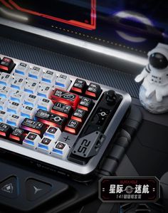 a keyboard with an astronaut figure next to it