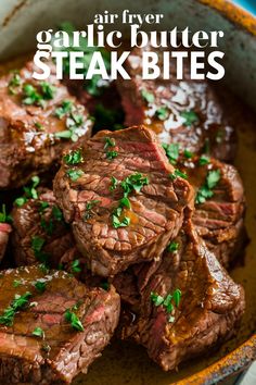 steak bites in a bowl with garnish on top and text overlay that reads air fryer garlic butter steak bites