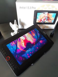 a tablet sitting on top of a table next to a box