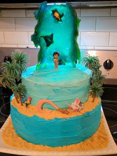 a cake that is decorated with an image of the little mermaid on top of it