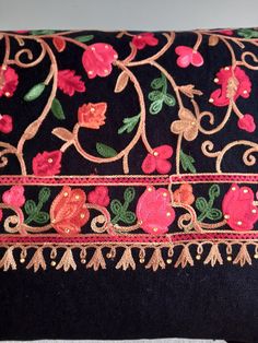 Elegant large embroidered shawl/ wrap. Made by hand with the highest quality. Luxiourios finish. Can wear to any occassion.  Colour: black with red floral design with                  gold stones throughout  Length:80 inches Width: 32 inches Dry clean only Shawl With Embroidered Border For Eid, Embroidered Shawl For Eid, Multicolor Jamawar Shawl With Embroidered Border, Multicolor Pashmina Shawl With Embroidered Border, Bohemian Pashmina Shawl With Intricate Embroidery, Pashmina Shawl With Multicolor Embroidered Border, Pashmina Shawl With Embroidered Border, Embroidered Pashmina Shawl, Eid Shawl Scarves With Embroidered Border