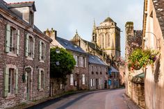 an empty street with old buildings in the background