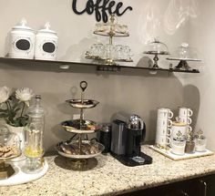 the coffee bar is stocked with cups and saucers