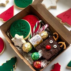 an open box filled with cookies and candies