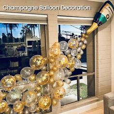 a room decorated with gold and silver balloons