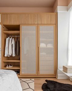 a bedroom with an open closet and white bed