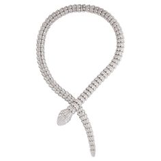 Bulgari Serpenti diamond snake necklace in 18k white gold, accompanied by Bulgari box. This striking Bulgari Serpenti piece features approximately 73.81 carats of round brilliant cut diamonds pave set over the entirety of the necklace, as well as 2 pear shape diamond eyes weighing approximately 1.00 carat. Total, there is approximately 74.81 carats. Numbered and signed BVLGARI. Snake Necklace Bulgari, Snake Diamond Necklace, Bvlgari Snake Necklace, Bvlgari Necklace Snake, Bvlgari Jewelry Necklaces, Bulgari Jewelry Necklaces, Bvlgari Jewelry Set, Necklace Bulgari, Bulgari Necklace