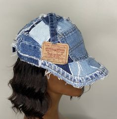 a mannequin's head wearing a denim hat with patches on the side