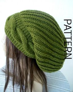 a green knitted hat sitting on top of a mannequin's head