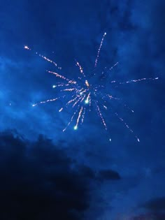 fireworks are lit up in the night sky with clouds and blue skies behind them,