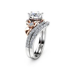 two tone gold and silver wedding ring set with diamonds on the sides, featuring an oval shaped