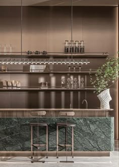 an elegant bar with marble counter tops and stools