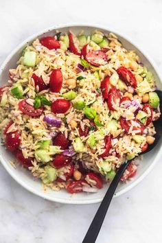 a white bowl filled with rice and vegetables