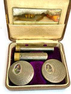 On offer: Antique Jonteel makeup set; all original and complete! Extremely rare makeup/beauty museum collectible boxed set! (bigbtmdrwrL.R) The brown leather covered box has a purple velvet, fitted bottom with cream satin pocket lid interior to hold the removable (original) glass mirror! This set includes 2 bronze/gunmetal tubes with side slider risers; the lipstick tube has dinged up interior and some remaining peach-colored lipstick. Shade not given. Lipstick missing the thumb slider button. B Peach Color Lipstick, Lipstick Tube, Rare Gifts, Black Eyeliner, Makeup Set, Purple Velvet, Makeup Kit, Toiletry Storage, Leather Cover