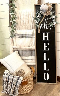 a sign that says oh, helo next to some towels and blankets in a basket