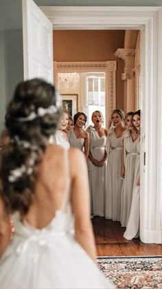 a bride looking at her reflection in the mirror as she gets ready to walk down the aisle