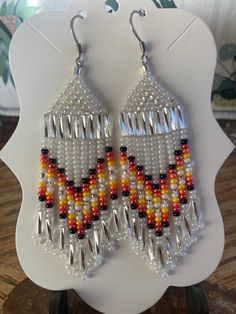 a pair of beaded earrings sitting on top of a table