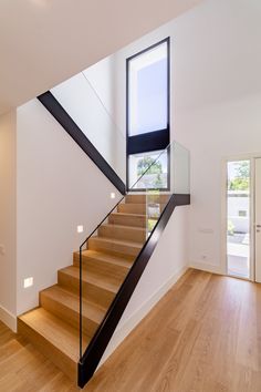 the stairs are made of glass and wood