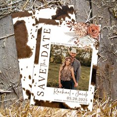 two wedding save the dates cards on top of some hay with flowers and rusted paint