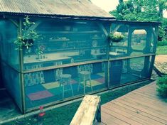 a chicken coop with chairs and tables in it