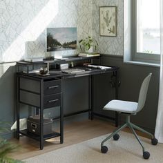 a desk with a computer on it and a chair next to it in front of a window