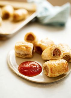 small pastries on a plate with ketchup