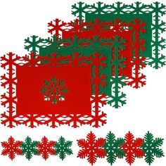 three red and green paper snowflakes on a white background